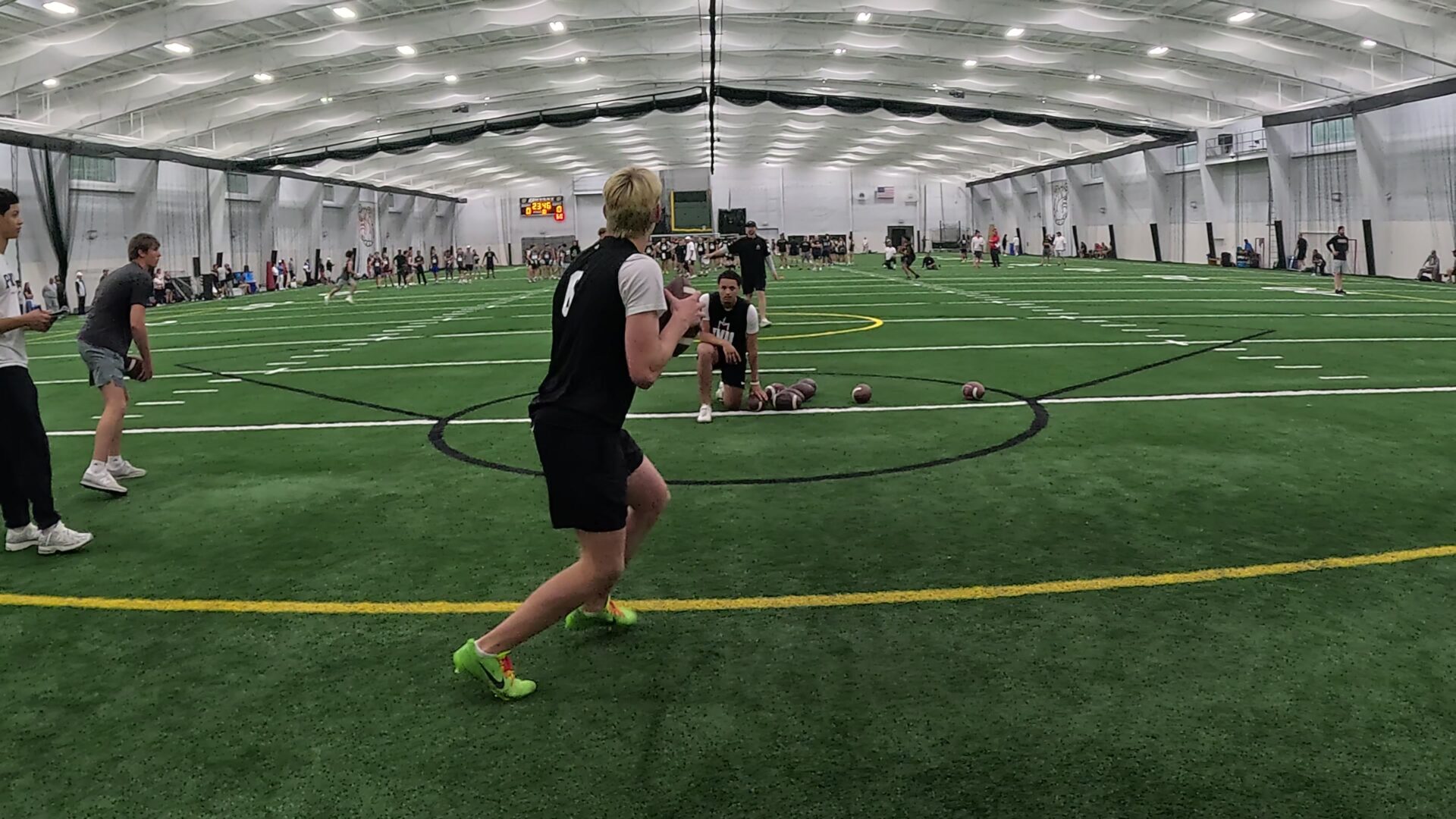 Indoor football training session with players practicing.