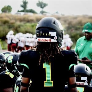 Football player wearing a black jersey with number 1 on the back.