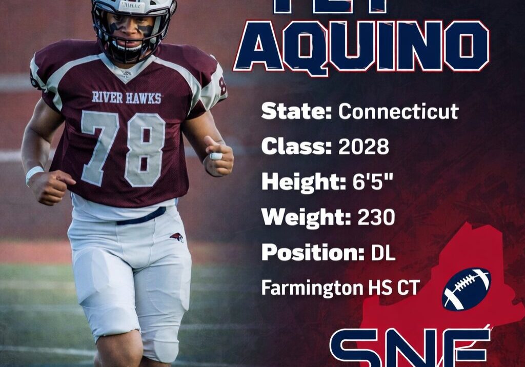 High school football player in maroon jersey running on field.